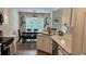 Well-lit kitchen with quartz countertops, stainless appliances, and open-concept dining at 3066 Gem Creek Rd, Buford, GA 30519