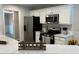 Bright kitchen with white cabinets, stainless steel appliances, and quartz countertops at 3066 Gem Creek Rd, Buford, GA 30519