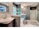 Bathroom featuring double sinks, granite counters, a bathtub, and a glass shower enclosure at 40 Legend Creek Chase, Douglasville, GA 30134