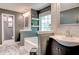 Bathroom showcasing dual sink vanity, standalone tub, wood-look floors, and natural lighting at 40 Legend Creek Chase, Douglasville, GA 30134