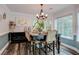 Traditional dining room with wood table, six chairs, decorative chandelier, and large windows at 40 Legend Creek Chase, Douglasville, GA 30134