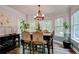 Traditional dining room with wood table, six chairs, decorative chandelier, and large windows at 40 Legend Creek Chase, Douglasville, GA 30134