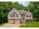Charming two-story home with a well-manicured lawn and two-car garage nestled among mature trees at 40 Legend Creek Chase, Douglasville, GA 30134