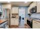View of updated kitchen with stainless steel appliances, custom cabinetry, and granite countertops at 40 Legend Creek Chase, Douglasville, GA 30134