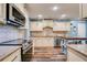 View of updated kitchen with stainless steel appliances, custom cabinetry, and granite countertops at 40 Legend Creek Chase, Douglasville, GA 30134