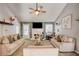 Cozy living room featuring vaulted ceiling, accent wall, neutral furniture, and lots of natural light at 40 Legend Creek Chase, Douglasville, GA 30134