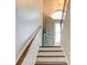 Staircase with a wood railing leading to an open doorway with a decorative arched window at 40 Legend Creek Chase, Douglasville, GA 30134