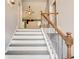 Elegant staircase featuring grey stairs, white risers, and wrought iron banister leading to upper level at 40 Legend Creek Chase, Douglasville, GA 30134