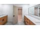 Bathroom featuring double vanities, an open door, and a large mirror at 2189 Spear Point Dr, Marietta, GA 30062