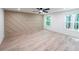 Spacious bedroom with a decorative wall, ceiling fan, and natural light from two windows at 2189 Spear Point Dr, Marietta, GA 30062