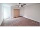 This is a bedroom with neutral walls, carpet, closet, and a ceiling fan at 2189 Spear Point Dr, Marietta, GA 30062