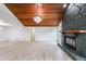 Spacious room with hardwood floors, stone fireplace, beamed wood ceilings and modern light fixture at 2189 Spear Point Dr, Marietta, GA 30062