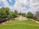 Aerial view of a landscaped park featuring a fountain, walking paths, and green spaces, ideal for community gatherings at 3620 W Lawrenceville St, Duluth, GA 30096