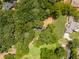 An aerial view of a property surrounded by lush trees, showcasing the landscape and privacy of the home at 3620 W Lawrenceville St, Duluth, GA 30096