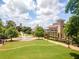 Aerial perspective of a well-manicured park with a fountain, trees, and manicured lawns offering a scenic atmosphere at 3620 W Lawrenceville St, Duluth, GA 30096