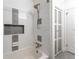 Bathroom featuring tiled walls, a shower-tub combination and in-wall storage at 3620 W Lawrenceville St, Duluth, GA 30096