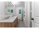 Bright bathroom features double sink vanity, decorative mirror and shower-tub combination at 3620 W Lawrenceville St, Duluth, GA 30096