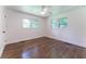 Bright bedroom with hardwood floors, white walls, and a ceiling fan at 3620 W Lawrenceville St, Duluth, GA 30096