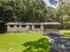 Charming home with a well-manicured lawn, dark asphalt driveway, and a welcoming front porch and carport at 3620 W Lawrenceville St, Duluth, GA 30096