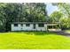 Charming single-story home with a manicured lawn, inviting porch, and attached carport providing curb appeal at 3620 W Lawrenceville St, Duluth, GA 30096