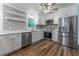 Renovated kitchen featuring stainless steel appliances and sleek white cabinetry at 3620 W Lawrenceville St, Duluth, GA 30096