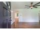 Bright living room featuring hardwood floors, ceiling fan, and a view into another room at 3620 W Lawrenceville St, Duluth, GA 30096