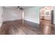 Open-concept living room with hardwood floors leading to a modern, renovated kitchen at 3620 W Lawrenceville St, Duluth, GA 30096