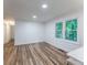 Bright, airy living room featuring hardwood floors and large windows overlooking the greenery at 3620 W Lawrenceville St, Duluth, GA 30096