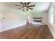 Spacious living room featuring hardwood floors, a ceiling fan, a fireplace, and natural light at 3620 W Lawrenceville St, Duluth, GA 30096