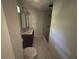 Bathroom with double sink, gray tile floor, and shower with gray subway tile at 4610 Wilson James Sw Rd, Atlanta, GA 30331