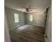 Bedroom featuring hardwood floors, ceiling fan, two windows and sliding barn door at 4610 Wilson James Sw Rd, Atlanta, GA 30331