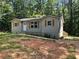 Charming single-story home with gray siding and wooden shutters nestled among mature trees at 4610 Wilson James Sw Rd, Atlanta, GA 30331