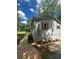 Charming house with gray siding and wooden shutters surrounded by lush greenery on a sunny day at 4610 Wilson James Sw Rd, Atlanta, GA 30331