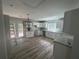 Bright kitchen with white cabinets, granite countertops, wood floors, and stainless steel sink at 4610 Wilson James Sw Rd, Atlanta, GA 30331