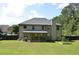 Large backyard features a covered patio and plenty of open grassy area at 5896 Cliftondale Dr, Atlanta, GA 30349