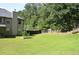 Lush backyard features a large, well-maintained lawn, mature trees, and fencing at 5896 Cliftondale Dr, Atlanta, GA 30349
