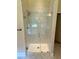 Bathroom featuring a frameless glass shower, marble tiling, and updated shower head at 5896 Cliftondale Dr, Atlanta, GA 30349