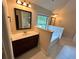 Bright bathroom featuring a marble countertop, garden tub and a large window at 5896 Cliftondale Dr, Atlanta, GA 30349