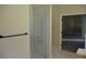 Bathroom featuring a glass door shower with marble tile surround and a view to the next room at 5896 Cliftondale Dr, Atlanta, GA 30349