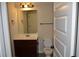 Bathroom featuring a sink with a granite countertop, toilet, and a mirror with lighting at 5896 Cliftondale Dr, Atlanta, GA 30349