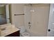 Clean bathroom design with a vanity, toilet, and shower-tub combination, and an open entry door at 5896 Cliftondale Dr, Atlanta, GA 30349