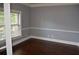 Bedroom featuring hardwood floors, neutral walls, and natural light streaming in through a window at 5896 Cliftondale Dr, Atlanta, GA 30349
