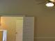 Bedroom features a ceiling fan and double doors to another room at 5896 Cliftondale Dr, Atlanta, GA 30349