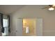 Bedroom with tray ceiling, window, ceiling fan, and doors leading to the next room at 5896 Cliftondale Dr, Atlanta, GA 30349