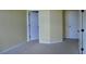 Bright bedroom with neutral walls, carpet and two white paneled doors at 5896 Cliftondale Dr, Atlanta, GA 30349