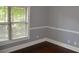 Bedroom featuring hardwood floors, neutral walls, and natural light streaming in through a window at 5896 Cliftondale Dr, Atlanta, GA 30349