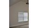 Light-filled bedroom featuring neutral walls, a window with blinds, and a projector mounted to the ceiling at 5896 Cliftondale Dr, Atlanta, GA 30349