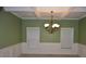 Dining room featuring wainscoting, coffered ceilings, and a traditional chandelier at 5896 Cliftondale Dr, Atlanta, GA 30349