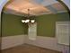 Elegant dining room showcasing coffered ceilings, wainscoting, and a stylish chandelier at 5896 Cliftondale Dr, Atlanta, GA 30349