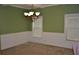 Elegant dining room showcasing coffered ceilings, wainscoting, and a stylish chandelier at 5896 Cliftondale Dr, Atlanta, GA 30349